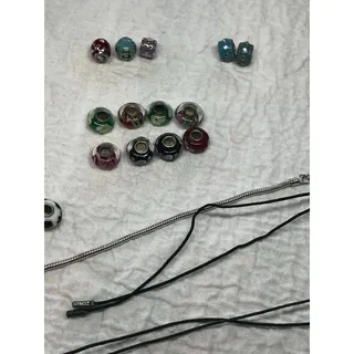 Photo of 31 slide charms unknown maker - some have makers mark + bracelet + Pandora cord
