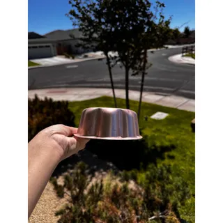 Photo of copper-tone aluminum oval sunburst jello mold or kitchen wall decor vintage