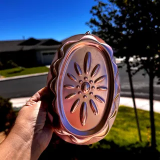 Photo of copper-tone aluminum oval Jell-O mold embossed floral sunburst pattern Vintage