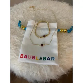 Photo of BaubleBar Tatum Ruby Bracelet paired with a matching necklace